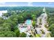 Aerial view of the community pool, clubhouse, parking, and surrounding lush green space near the lake at 1065 Beacon Hill Xing, Alpharetta, GA 30005
