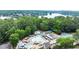 Aerial view of the community pool area with waterslides, splash pad, and lake views beyond the trees at 1065 Beacon Hill Xing, Alpharetta, GA 30005