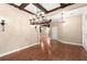 Spacious dining room featuring wood floors, coffered ceilings, and elegant chandeliers for a luxurious feel at 1065 Beacon Hill Xing, Alpharetta, GA 30005