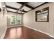 Dining area showcasing hardwood floors, wood beam ceilings, a decorative mirror, and sconce lighting at 1065 Beacon Hill Xing, Alpharetta, GA 30005