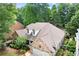 Overhead view of brick home with manicured lawn and attached two car garage, enhancing curb appeal at 1065 Beacon Hill Xing, Alpharetta, GA 30005