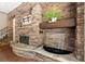 Stone fireplace with decorative water feature is the focal point of this living room at 1065 Beacon Hill Xing, Alpharetta, GA 30005