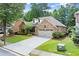 Lovely brick home with a two-car garage, neatly kept lawn, and inviting curb appeal at 1065 Beacon Hill Xing, Alpharetta, GA 30005