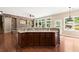 Open kitchen with stone island, granite countertops, and dark wood cabinets at 1065 Beacon Hill Xing, Alpharetta, GA 30005