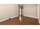Hardwood flooring throughout a room with wall to wall tan paint and white molding at 1065 Beacon Hill Xing, Alpharetta, GA 30005