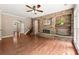 Living room with a stone fireplace, hardwood floors, and staircase access at 1065 Beacon Hill Xing, Alpharetta, GA 30005