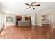 Spacious living room leading to a kitchen with a stone island and a view of the backyard at 1065 Beacon Hill Xing, Alpharetta, GA 30005