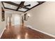 Bright, open-concept living room featuring hardwood floors and a beamed ceiling with a fan at 1065 Beacon Hill Xing, Alpharetta, GA 30005