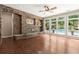 Bright living room with stone fireplace and large windows with a view of the pool area at 1065 Beacon Hill Xing, Alpharetta, GA 30005