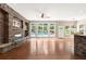 Open living room boasts a stone fireplace and large windows overlooking the pool at 1065 Beacon Hill Xing, Alpharetta, GA 30005