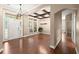 Spacious living room featuring hardwood floors, natural light, and decorative ceiling beams with modern chandelier at 1065 Beacon Hill Xing, Alpharetta, GA 30005