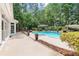 In-ground pool features a sunning deck surrounded by brick coping and mature landscaping at 1065 Beacon Hill Xing, Alpharetta, GA 30005