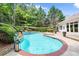 Beautiful in-ground pool surrounded by mature landscaping and brick coping at 1065 Beacon Hill Xing, Alpharetta, GA 30005