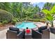 Lounge by the sparkling blue pool surrounded by professionaly landscaped yard at 1065 Beacon Hill Xing, Alpharetta, GA 30005