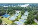 Aerial view showcases the community's well-maintained tennis courts near lake, promoting an active lifestyle at 1065 Beacon Hill Xing, Alpharetta, GA 30005