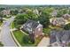 Aerial shot of home with beautifully landscaped yard, long driveway, and established neighborhood at 2444 Mossy Branch Dr, Snellville, GA 30078