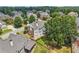 Aerial view of the house situated in a neighborhood with mature trees and well-maintained lawns at 2444 Mossy Branch Dr, Snellville, GA 30078