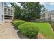 Expansive backyard with lush green grass, mature trees, and a glimpse of the home's porch at 2444 Mossy Branch Dr, Snellville, GA 30078
