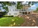 Lush backyard featuring mature trees, a lawn, and a view of the home's raised back porch at 2444 Mossy Branch Dr, Snellville, GA 30078