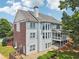 Exterior shot showcasing the back of the house with a deck, yard, and mature trees at 2444 Mossy Branch Dr, Snellville, GA 30078