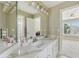 Bathroom featuring double sinks, a large mirror, and bright lighting at 2444 Mossy Branch Dr, Snellville, GA 30078