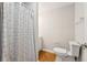Bathroom showcasing a shower with a curtain and a standard toilet at 2444 Mossy Branch Dr, Snellville, GA 30078