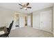 Spacious bedroom with neutral walls, carpet, ceiling fan, closet, and ensuite bathroom at 2444 Mossy Branch Dr, Snellville, GA 30078
