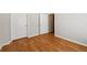 Bedroom showcasing hardwood floors, neutral walls, and closet space at 2444 Mossy Branch Dr, Snellville, GA 30078