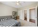 Bedroom features neutral walls, carpet, ceiling fan, closet, and ensuite bathroom at 2444 Mossy Branch Dr, Snellville, GA 30078
