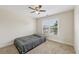 Neutral bedroom with tan carpet, white trim, ceiling fan and a window for natural light at 2444 Mossy Branch Dr, Snellville, GA 30078