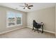 Neutral bedroom with a ceiling fan, carpeted floor, and large window with blinds at 2444 Mossy Branch Dr, Snellville, GA 30078