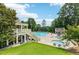 Community pool area featuring a pool, kiddie pool, and plenty of lounge chairs for relaxation at 2444 Mossy Branch Dr, Snellville, GA 30078