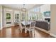 Dining room with hardwood floors and access to outdoor seating area with views of the living room at 2444 Mossy Branch Dr, Snellville, GA 30078