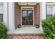 Elegant double front doors framed by brick columns with detailed trim and decor at 2444 Mossy Branch Dr, Snellville, GA 30078
