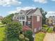 Charming two-story brick home with lush landscaping and a well-manicured lawn at 2444 Mossy Branch Dr, Snellville, GA 30078