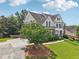 Well-manicured front yard with lush landscaping and a charming brick home at 2444 Mossy Branch Dr, Snellville, GA 30078