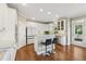 Well-lit kitchen with stainless steel appliances, breakfast bar, and hardwood flooring at 2444 Mossy Branch Dr, Snellville, GA 30078