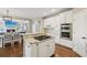 Kitchen island with countertop cooktop; eat in kitchen with view to the living room at 2444 Mossy Branch Dr, Snellville, GA 30078