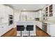 Kitchen with stainless steel appliances, breakfast bar, and white cabinetry at 2444 Mossy Branch Dr, Snellville, GA 30078
