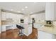 Bright kitchen with white cabinets, stainless appliances and a breakfast bar seating area at 2444 Mossy Branch Dr, Snellville, GA 30078