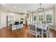 Eat-in kitchen with stainless steel appliances, white cabinetry, and hardwood flooring at 2444 Mossy Branch Dr, Snellville, GA 30078