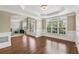 Spacious living room with hardwood floors, large windows, and elegant architectural details at 2444 Mossy Branch Dr, Snellville, GA 30078