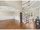 Elegant living room featuring hardwood floors, detailed trim, and a staircase at 2444 Mossy Branch Dr, Snellville, GA 30078