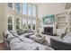 Elegant living room with a fireplace, built-in shelves, and soaring windows for abundant natural light at 2444 Mossy Branch Dr, Snellville, GA 30078