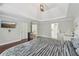 Large main bedroom with hardwood floors and tray ceilings at 2444 Mossy Branch Dr, Snellville, GA 30078