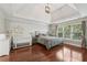 Spacious main bedroom with hardwood floors and multiple windows at 2444 Mossy Branch Dr, Snellville, GA 30078
