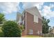 Side view of the brick home, showing the architectural design and the surrounding yard at 2444 Mossy Branch Dr, Snellville, GA 30078