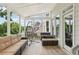 Inviting sunroom with comfortable seating, bright natural light, and beautiful outdoor views at 2444 Mossy Branch Dr, Snellville, GA 30078