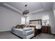Cozy bedroom featuring a large bed, side tables with lamps and a modern ceiling fixture at 3227 Hidden Valley Cir, Lawrenceville, GA 30044