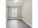 Bedroom with hardwood floors and a large window offering natural light at 971 Sims Nw Ave, Atlanta, GA 30318